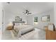 Spacious main bedroom featuring a ceiling fan, neutral tones, and decor at 36 Pine Radl, Ocala, FL 34472
