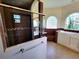 Well-lit bathroom featuring walk-in shower, walk-in tub, and tile flooring at 3803 Se 6Th Ave, Ocala, FL 34480