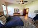 Serene bedroom with hardwood floors, a ceiling fan, and an ensuite bathroom at 3803 Se 6Th Ave, Ocala, FL 34480
