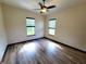 Bright bedroom featuring wood-look flooring, two windows, and plenty of space at 3803 Se 6Th Ave, Ocala, FL 34480