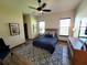 Comfortable bedroom with hardwood floors, a ceiling fan, and large windows for natural light at 3803 Se 6Th Ave, Ocala, FL 34480