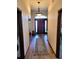 Inviting hallway featuring a decorative rug and chandelier leading to the front door at 3803 Se 6Th Ave, Ocala, FL 34480