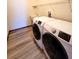 Bright laundry area with new appliances, sink, shelving, and wood-look flooring at 3803 Se 6Th Ave, Ocala, FL 34480