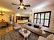 Open-concept living room featuring hardwood floors, a stylish ceiling fan, and abundant natural light at 3803 Se 6Th Ave, Ocala, FL 34480