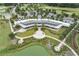 An aerial view of the community clubhouse with manicured lawns, water features, and ample parking at 4474 Nw 53Rd Ave Rd, Ocala, FL 34480