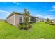 Well-maintained backyard with lush green grass, shrubs, and a privacy fence at 4474 Nw 53Rd Ave Rd, Ocala, FL 34480