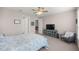 Bedroom with neutral tones, a comfortable bed, and an accent chair, creating a relaxing atmosphere at 4474 Nw 53Rd Ave Rd, Ocala, FL 34480