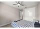 Bedroom featuring a ceiling fan, closet with white sliding doors, and neutral walls at 4474 Nw 53Rd Ave Rd, Ocala, FL 34480
