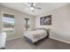 Cozy bedroom with two windows bringing in ample light and a ceiling fan for added comfort at 4474 Nw 53Rd Ave Rd, Ocala, FL 34480