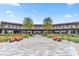 Stunning exterior of a community building with outdoor seating areas, lush landscaping, and palm trees at 4474 Nw 53Rd Ave Rd, Ocala, FL 34480