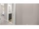 Hallway view leading to a bathroom showcasing the home's seamless flow and neutral color palette at 4474 Nw 53Rd Ave Rd, Ocala, FL 34480