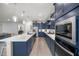 Modern kitchen features navy cabinets, stainless steel appliances, and quartz countertops at 4474 Nw 53Rd Ave Rd, Ocala, FL 34480