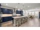 Open concept kitchen with blue cabinets, quartz countertops, stainless steel appliances, and a large island with seating at 4474 Nw 53Rd Ave Rd, Ocala, FL 34480