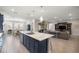 Open concept kitchen with navy island, stainless steel appliances, and seamless flow to dining and living areas at 4474 Nw 53Rd Ave Rd, Ocala, FL 34480