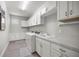 Bright laundry room with plenty of cabinet space and a washing machine and dryer at 4474 Nw 53Rd Ave Rd, Ocala, FL 34480
