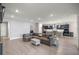 Spacious living room showcasing a comfortable sectional sofa and an open layout with the kitchen and dining area at 4474 Nw 53Rd Ave Rd, Ocala, FL 34480