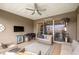Comfortable covered patio with a ceiling fan, TV, grill, and patio furniture for relaxing and entertaining at 4474 Nw 53Rd Ave Rd, Ocala, FL 34480