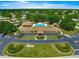 Community center aerial view featuring a pool, clubhouse, meticulously landscaped grounds, and convenient parking areas at 6172 Sw 101St Pl, Ocala, FL 34476