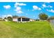 Large grassy backyard perfect for outdoor activities, featuring a screened lanai and a well-maintained perimeter fence at 6172 Sw 101St Pl, Ocala, FL 34476