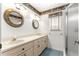 Bathroom with double sinks, vanity, and glass-enclosed shower at 6172 Sw 101St Pl, Ocala, FL 34476