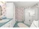Bathroom featuring floral wallpaper, glass shower, vanity with storage, and bathtub at 6172 Sw 101St Pl, Ocala, FL 34476