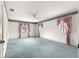 Spacious bedroom with blue carpeting, two windows, and floral wallpaper border at 6172 Sw 101St Pl, Ocala, FL 34476