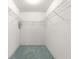 Walk-in closet with wire shelving and teal carpeting for ample storage space at 6172 Sw 101St Pl, Ocala, FL 34476