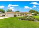 Inviting home with lush green lawn, mature trees, and a spacious driveway leading to a two-car garage at 6172 Sw 101St Pl, Ocala, FL 34476