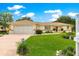 Charming single-story home with a well-manicured lawn, lovely landscaping, and attached two-car garage at 6172 Sw 101St Pl, Ocala, FL 34476