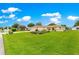 Inviting front yard featuring a well-maintained lawn and mature landscaping, offering great curb appeal at 6172 Sw 101St Pl, Ocala, FL 34476