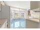 Bright eat-in kitchen with blue tile floors, bay window, and white cabinetry at 6172 Sw 101St Pl, Ocala, FL 34476