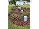 View of attractive landscaping with a charming water feature and garden gnome in a meticulously maintained garden at 6172 Sw 101St Pl, Ocala, FL 34476