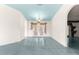 Spacious living area with tile flooring, elegant chandelier, and doors to a backyard patio at 6172 Sw 101St Pl, Ocala, FL 34476