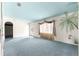 Comfortable living room with a blue ceiling, wall art, and large window with curtains at 6172 Sw 101St Pl, Ocala, FL 34476
