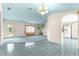 Bright and airy living room featuring a door to the outside and open access to the kitchen space at 6172 Sw 101St Pl, Ocala, FL 34476