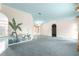 Open living room featuring carpeted and tiled flooring, unique design, and natural light at 6172 Sw 101St Pl, Ocala, FL 34476