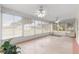 Bright sunroom with many windows and ceiling fans at 6172 Sw 101St Pl, Ocala, FL 34476