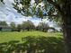 Expansive backyard with mature trees, a shed, and lush green grass at 6773 Se 87Th St, Ocala, FL 34472