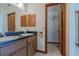 Bathroom featuring a double sink vanity with wood cabinets and an open closet at 6773 Se 87Th St, Ocala, FL 34472