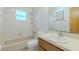 Bright, tiled bathroom features a bathtub, shower, and vanity with sink at 6773 Se 87Th St, Ocala, FL 34472