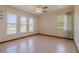 Bright bedroom features multiple windows, a ceiling fan, and tile flooring at 6773 Se 87Th St, Ocala, FL 34472