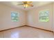 Cozy bedroom with tile floors and natural light from dual windows at 6773 Se 87Th St, Ocala, FL 34472