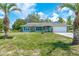 Charming home featuring stone accents, well-manicured lawn, and an attached garage at 6773 Se 87Th St, Ocala, FL 34472