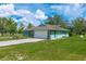 Angle view of house, showcasing large garage door, and well maintained green lawn at 6773 Se 87Th St, Ocala, FL 34472
