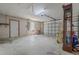 Spacious garage with concrete floor, a rolling door, and ample space at 6773 Se 87Th St, Ocala, FL 34472