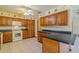 Bright kitchen boasts tile flooring, dark countertops, and wood cabinetry at 6773 Se 87Th St, Ocala, FL 34472