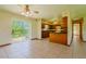 Open kitchen and dining area with wood cabinets and sliding glass door to yard at 6773 Se 87Th St, Ocala, FL 34472
