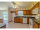 Traditional kitchen featuring wood cabinets, white appliances, and an eat-in area at 6773 Se 87Th St, Ocala, FL 34472