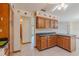 Spacious eat-in kitchen with dark counters and tile floor that leads into another room at 6773 Se 87Th St, Ocala, FL 34472