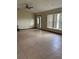 Spacious living room with neutral tile flooring, ceiling fan, and large windows providing ample natural light at 6773 Se 87Th St, Ocala, FL 34472